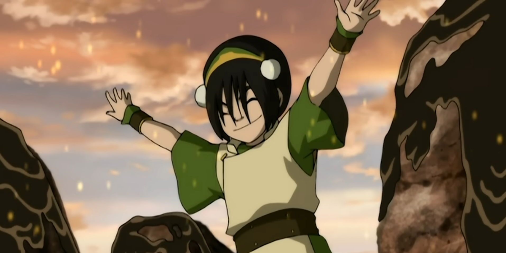 Toph in her green outfit is stretching out hands out in Avatar The Last Airbender