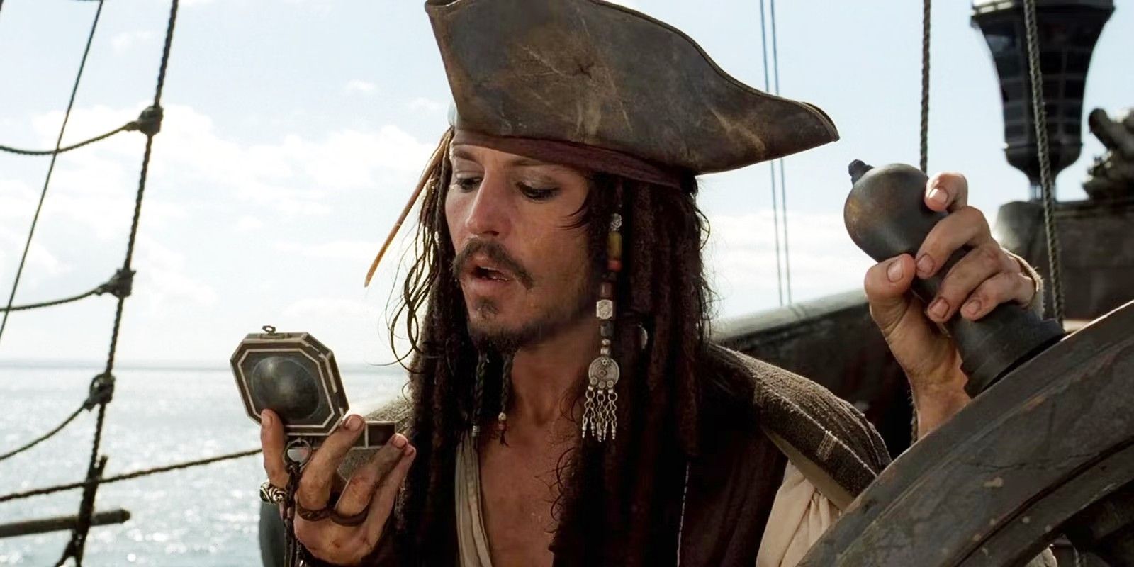 Johnny Depp as Jack Sparrow checks his compass in Pirates of the Caribbean: The Curse of the Black Pearl