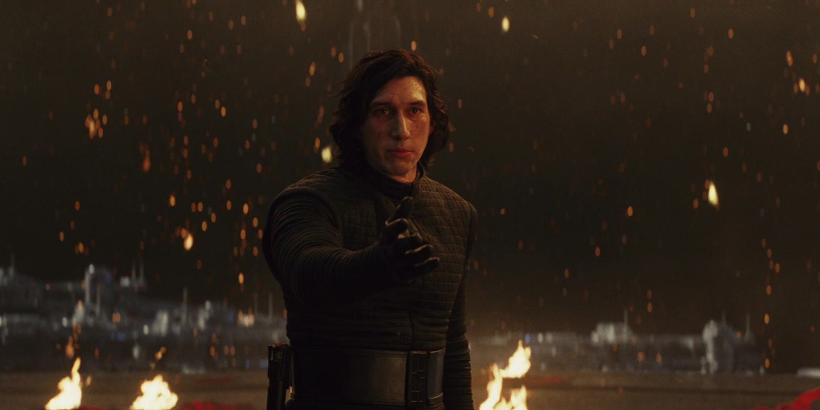 Kylo Ren holding out his hand with the throne room burning in the background