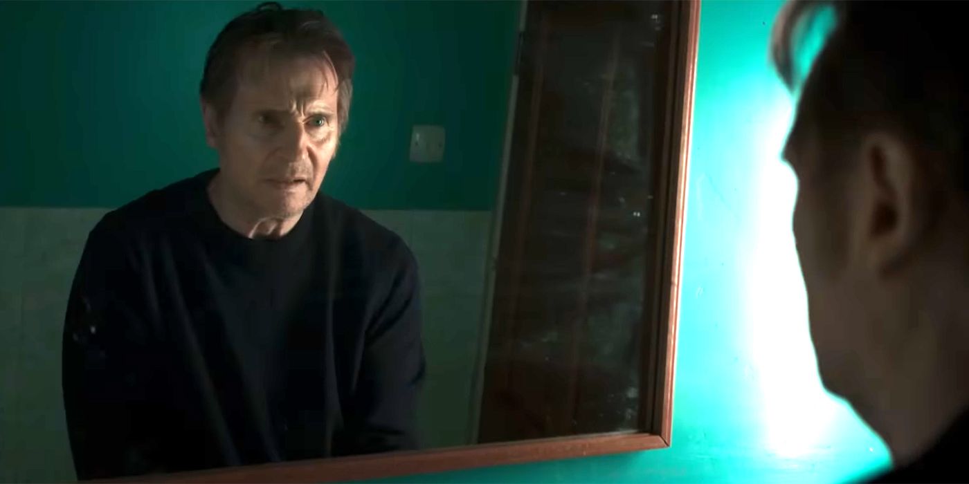 Liam Neeson as Finbar looking wearily in the mirror in In the Land of Saints and Sinners