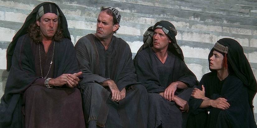 Four Pythons sitting on the steps in Monty Python Life of Brian