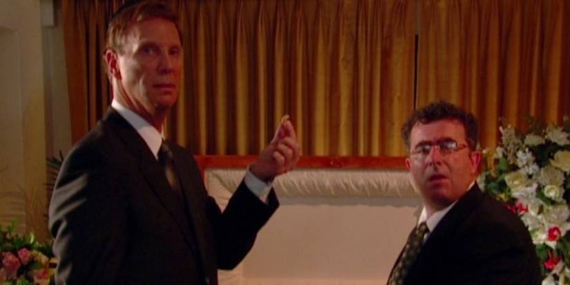 Marty and Saul next to a coffin in Curb Your Enthusiasm