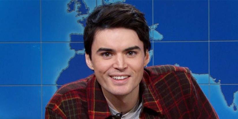 Michael Longfellow smiling on Weekend Update on SNL.