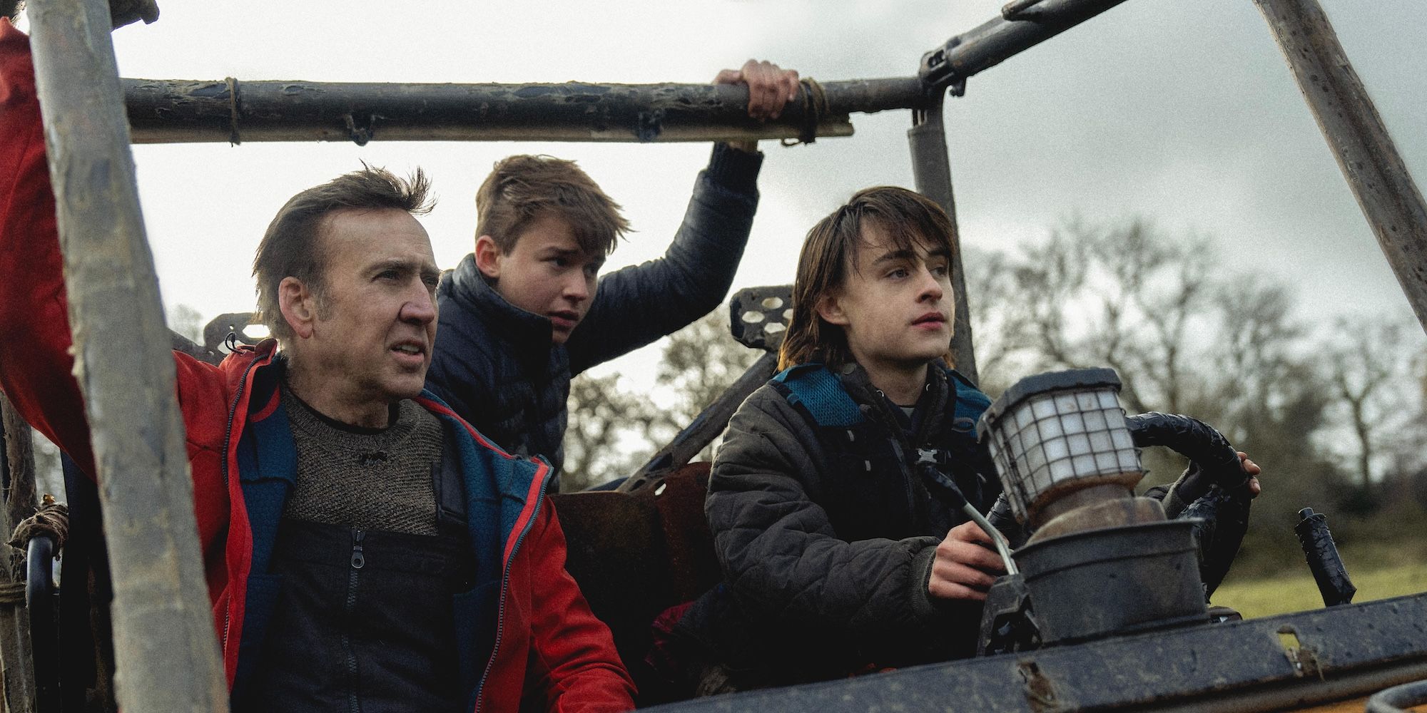 Nicolas Cage's Paul rides in a truck with his onscreen sons in Arcadian movie still