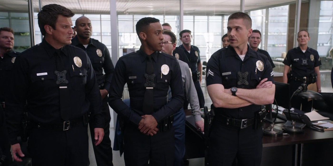 Nolan (Nathan Fillion) standing with fellow officers in The Rookie