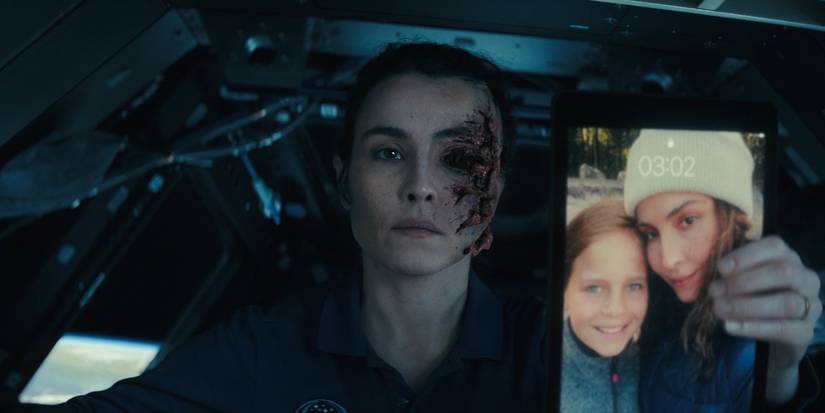 Noomi Rapace's Jo holding an iPad in the International Space Station in Constellation's finale