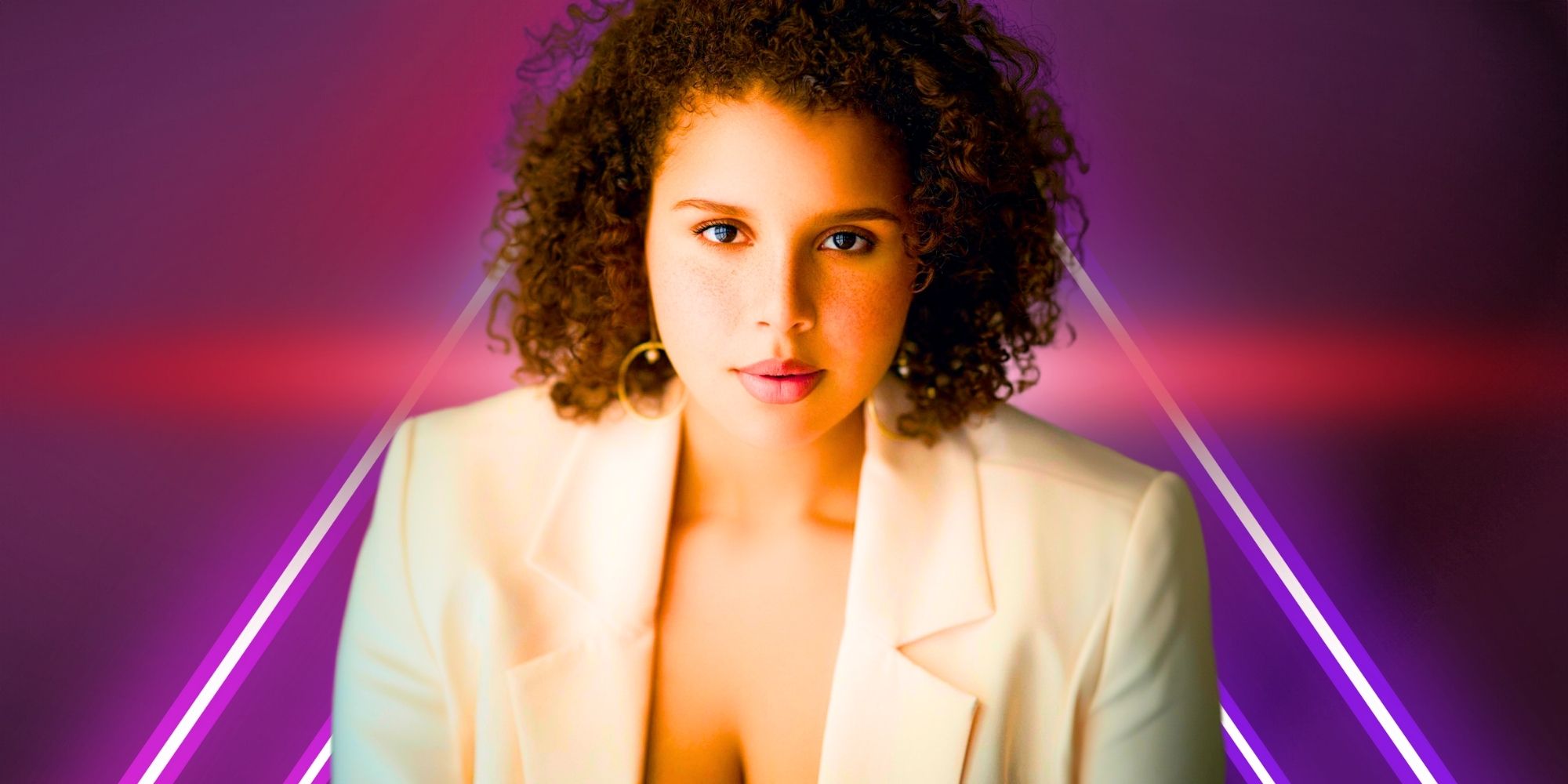 The Family Chantel Winter Everett wearing white blazer short curly hair