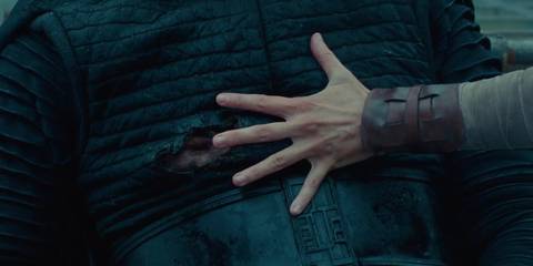 Rey holding her hand over Kylo Ren's wound to heal it in The Rise of Skywalker