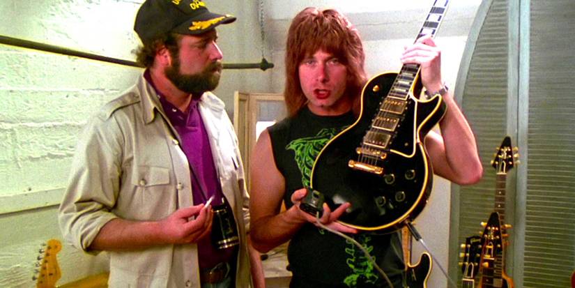 Christopher Guest shows Rob Reiner his guitar in a scene from This is Spinal Tap