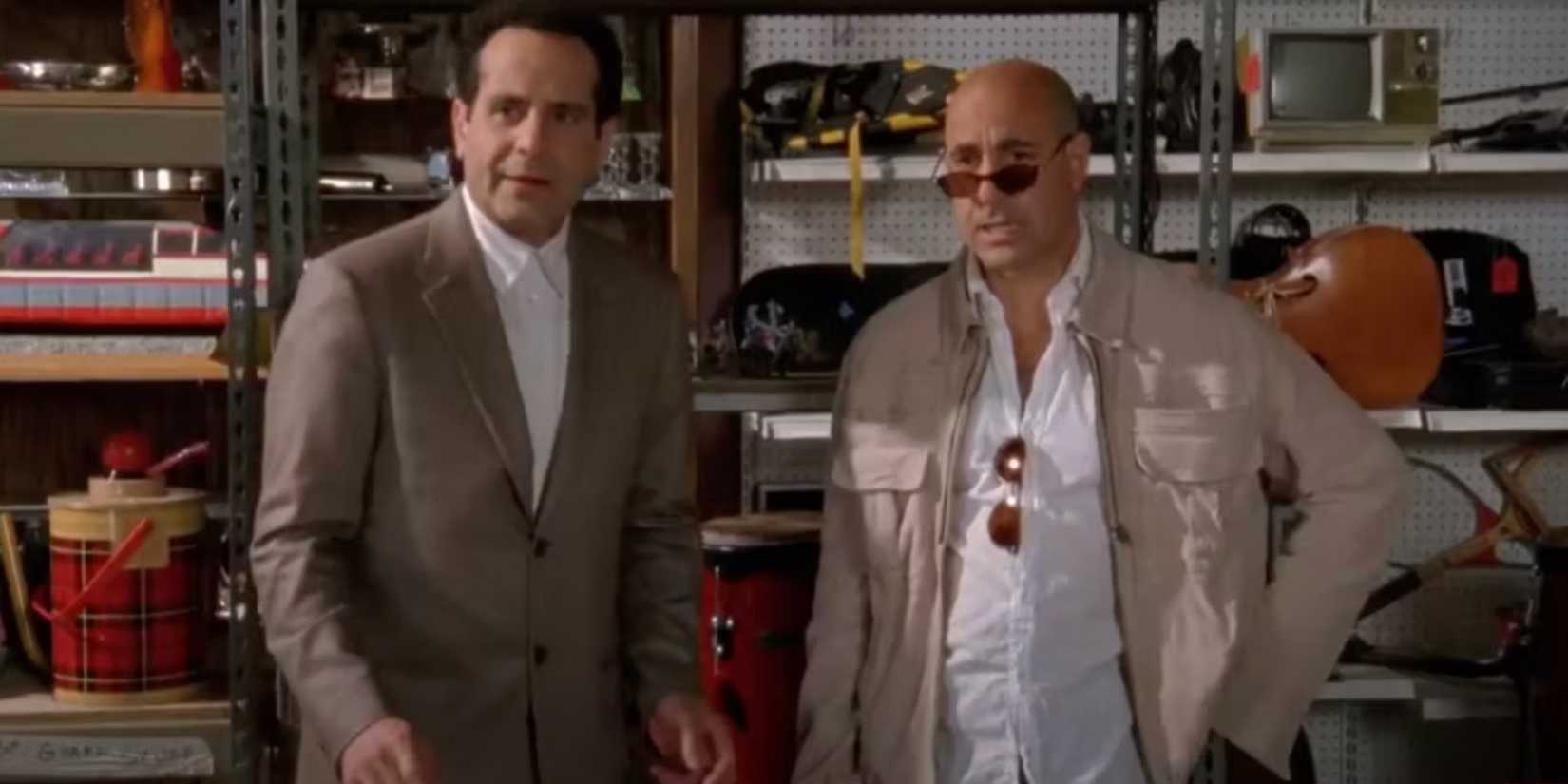 Stanley Tucci and Tony Shaloub standing together in a storage space in Monk