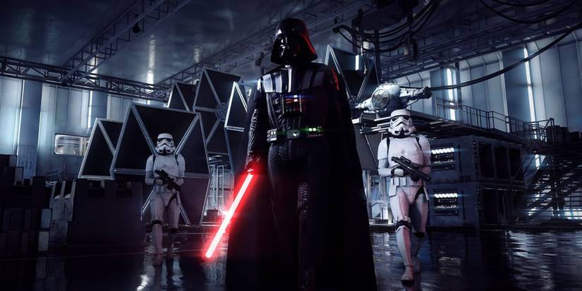 Darth Vader walking with two storm troopers behind him in Star Wars: Battlefront 2