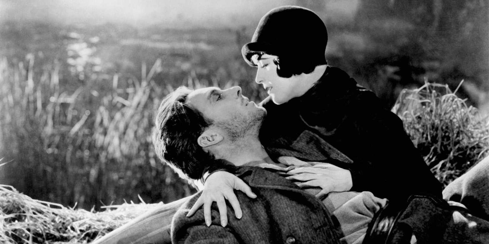 George O'Brien & Margaret Livingston embrace in a field in Sunrise (1927)