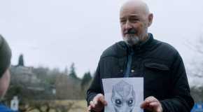 Terry O'Quinn as Peter Bach holding a drawing of an alien in Resident Alien