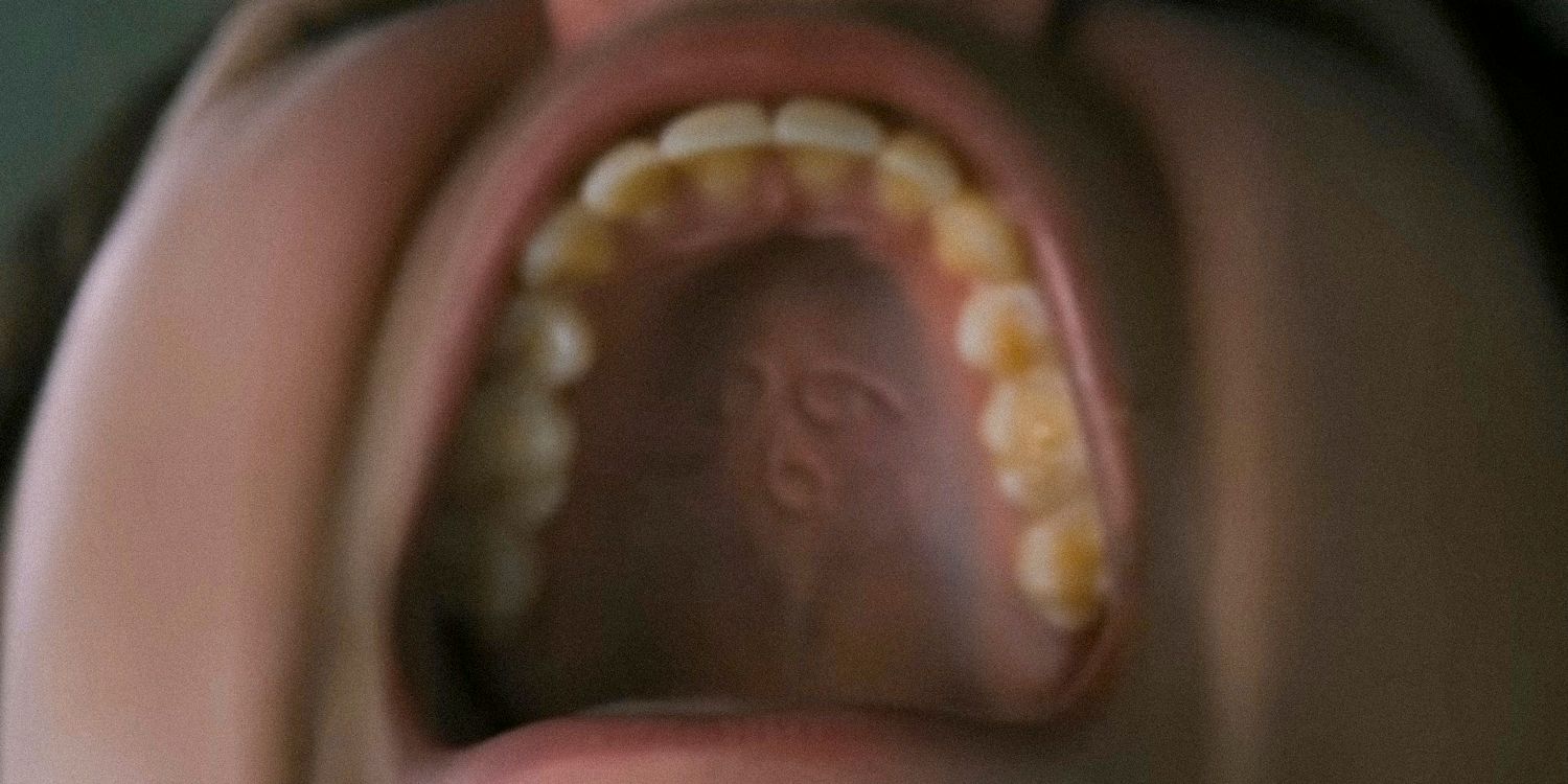 The mark of a symbol on someone's palate in The First Omen
