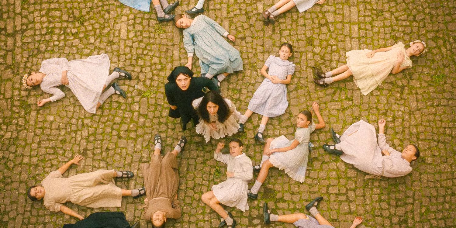 Aerial shot with Margaret and Carlita in the center and some orphanage girls lying on the floor around them in The First Omen