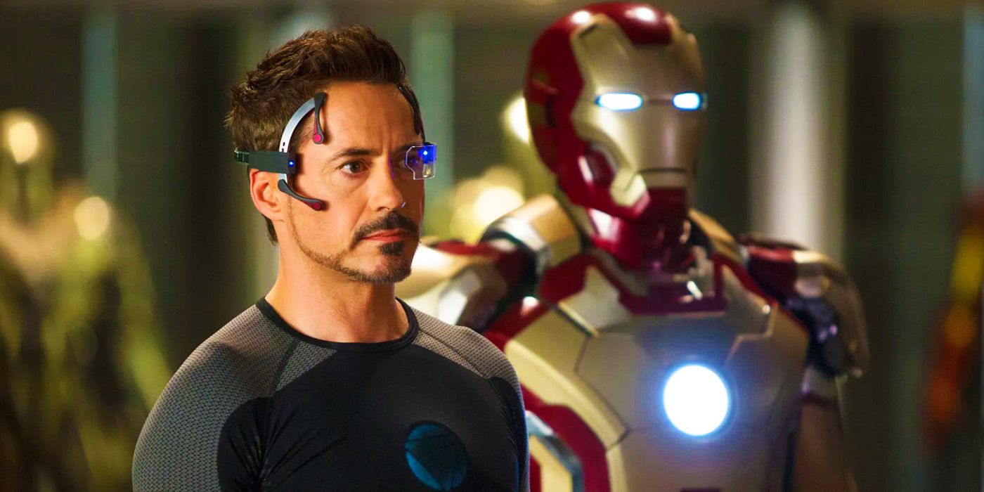 Tony Stark wears headgear and stands with his Iron Man suit in Iron Man 3