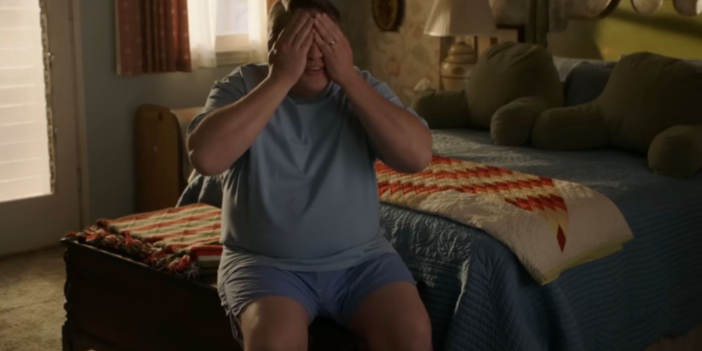 George Sr. sitting on his bed with his hands over his eyes in Young Sheldon season 7.