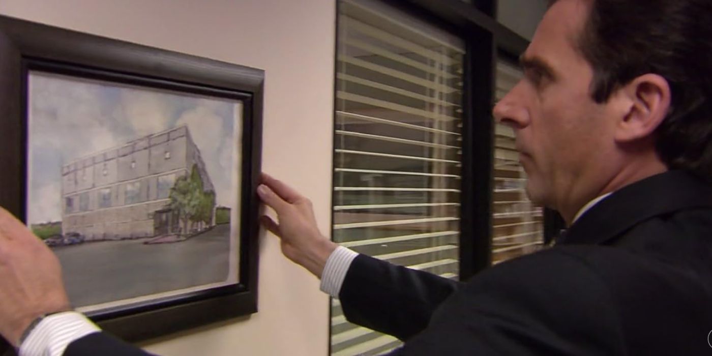 Michael hanging Pam's painting of the office on the wall in The Office