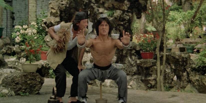 Jackie Chan as Wong being taunted by his master as he trains in Drunken Master
