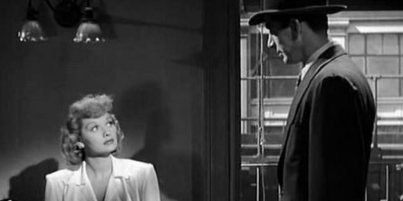 Kathleen looking up at Galt from her desk in The Dark Corner (1946)