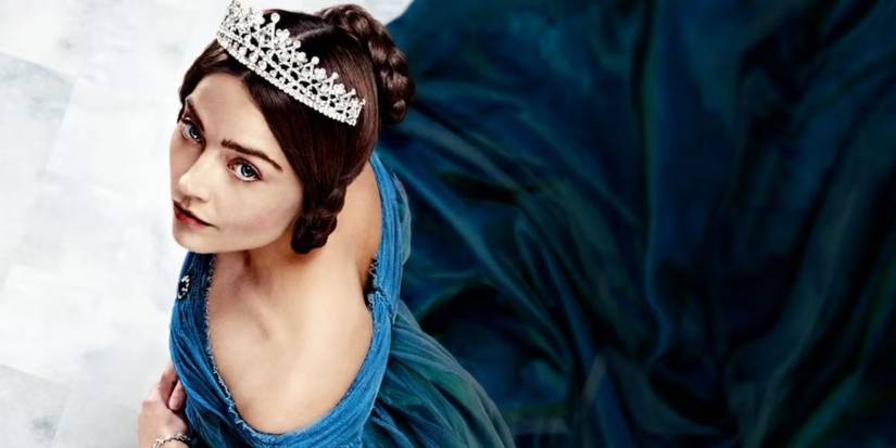 Jenna Coleman as Queen Victoria in a blue dress and looking up in Victoria