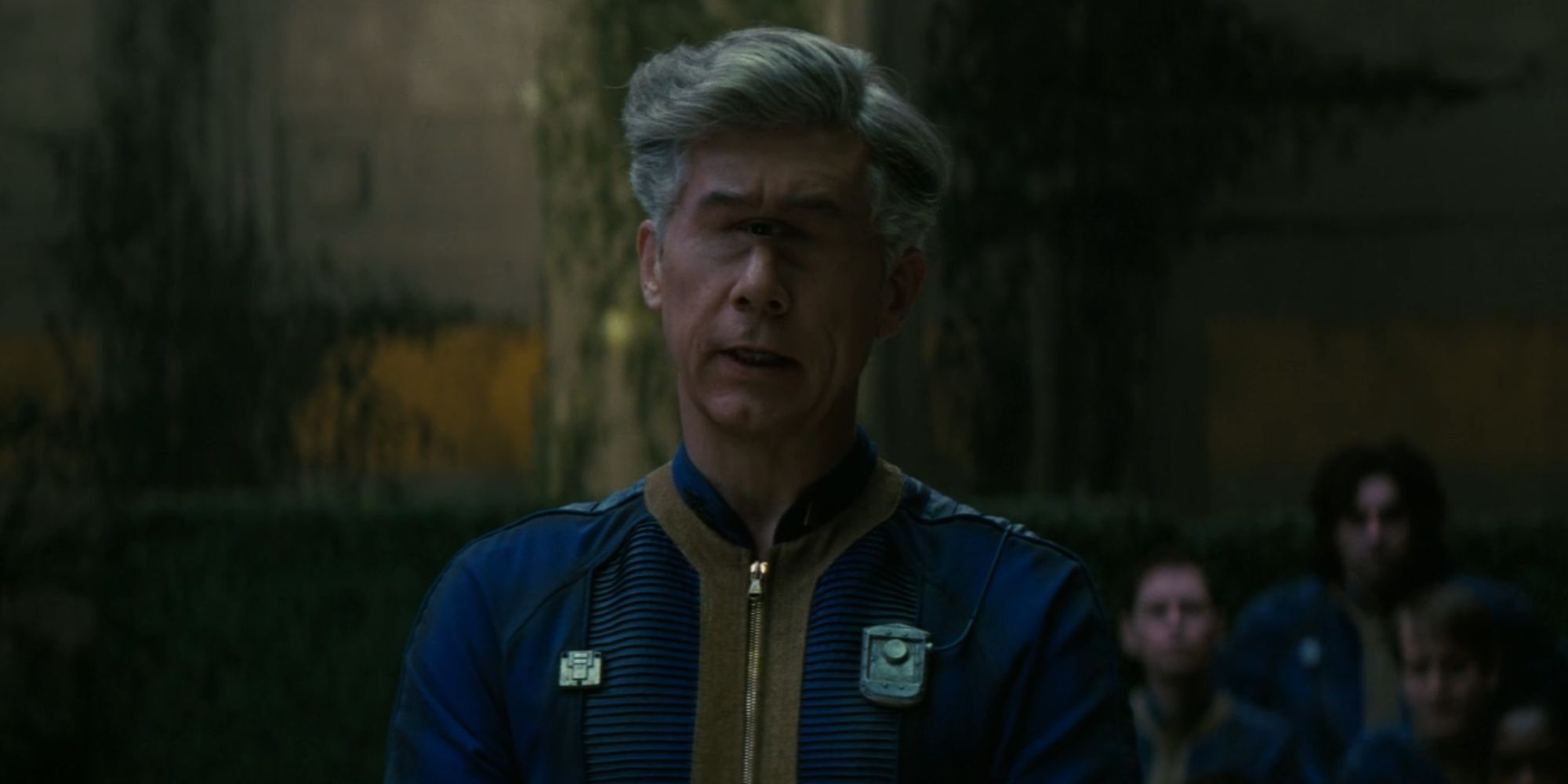 Chris Parnell as Overseer Benjamin in Fallout in the dark looking serious