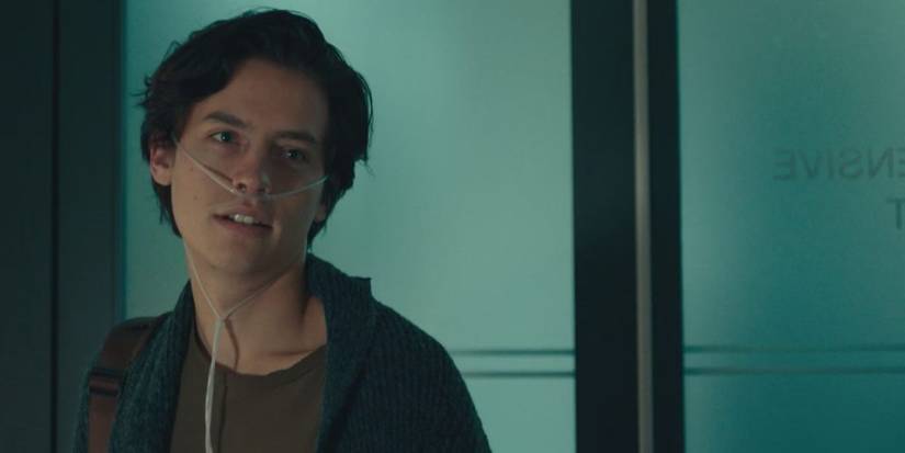Cole Sprouse wearing a breathing tube and looking at someone offscreen in Five Feet Apart