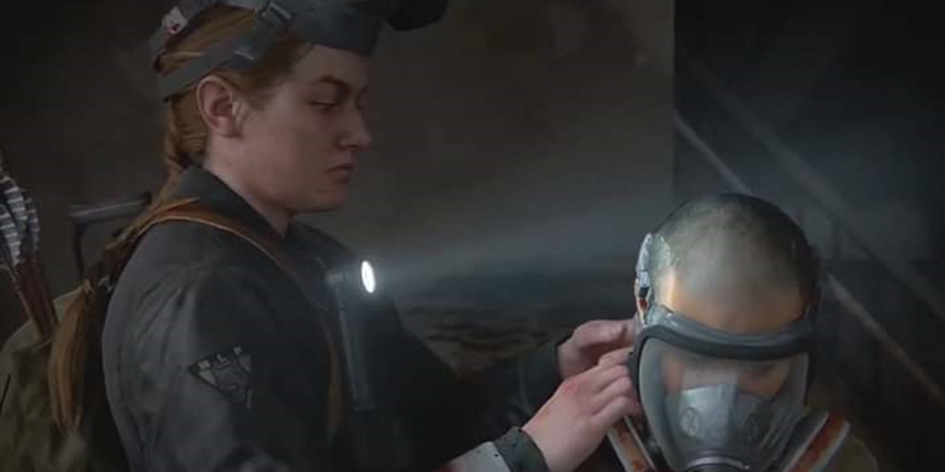 Abby helps Lev with his gas mask in The Last of Us Part II