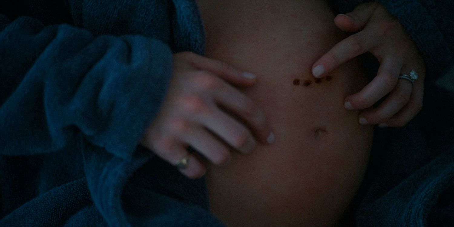 Close-up of Anna Victoria Alcott's pregnant belly with some marks in American Horror Story: Delicate season 12 ep 6