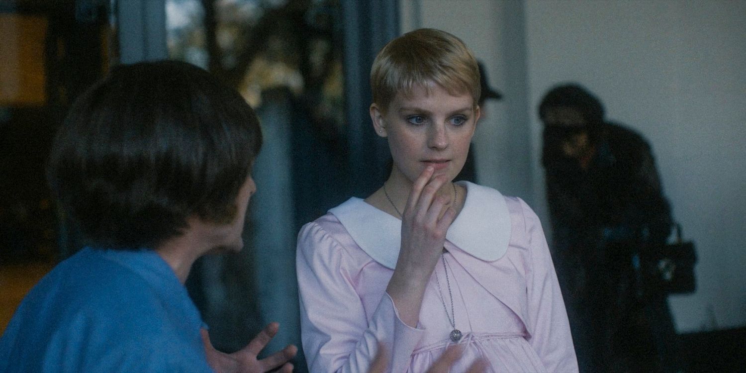 Mia Farrow looks pensive on the set of a movie in American Horror Story: Delicate season 12 Ep 8