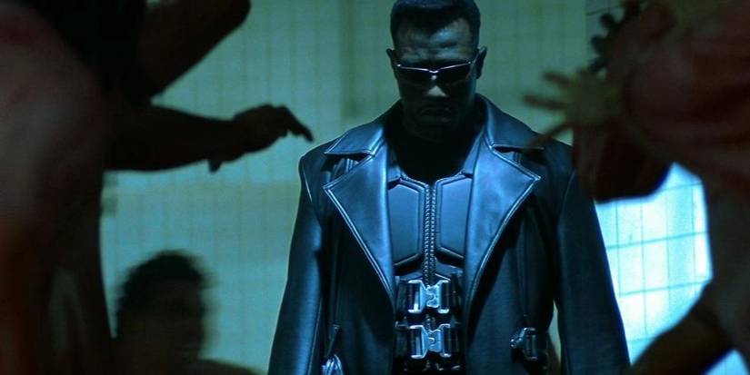 Wesley Snipes as Blade surrounded by shadowy vampire hands in Blade (1998)