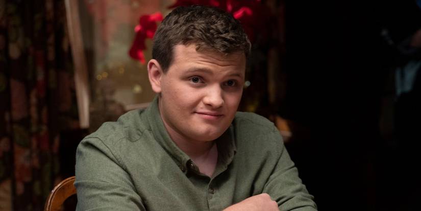 Blue Bloods Sean sitting at the family table with an impish grin