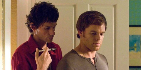 Brian Moser standing behind Dexter with a syringe in Dexter season 1