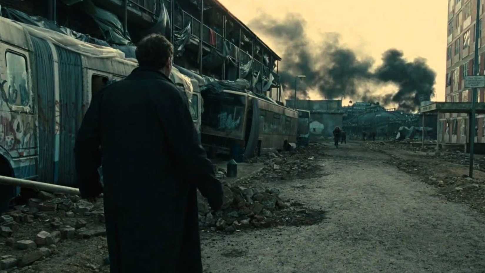 Theo (Clive Owen) looking out over a destroyed landscape in Children of Men.
