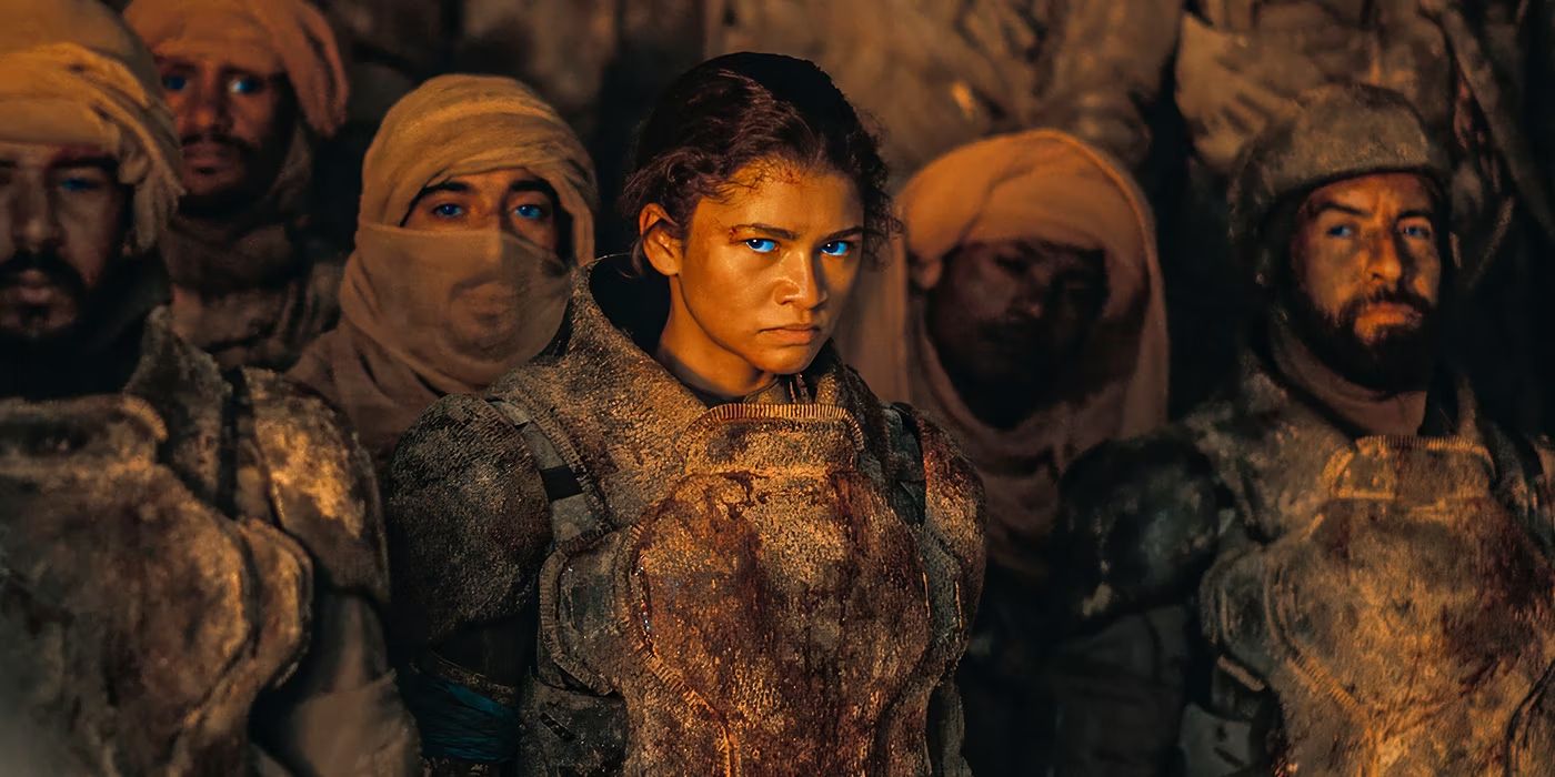 Chani, played by Zendaya, stares angrily at Paul Atreides in Dune: Part Two. She is surrounded by other Fremen fighters, and she has a look of betrayal.