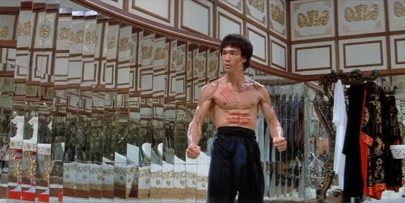 Lee stands poised in a hall of mirror in Enter the Dragon