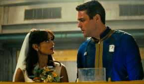 Lucy MacLean, dressed in a wedding gown, talks to Chet before her wedding in Fallout season 1