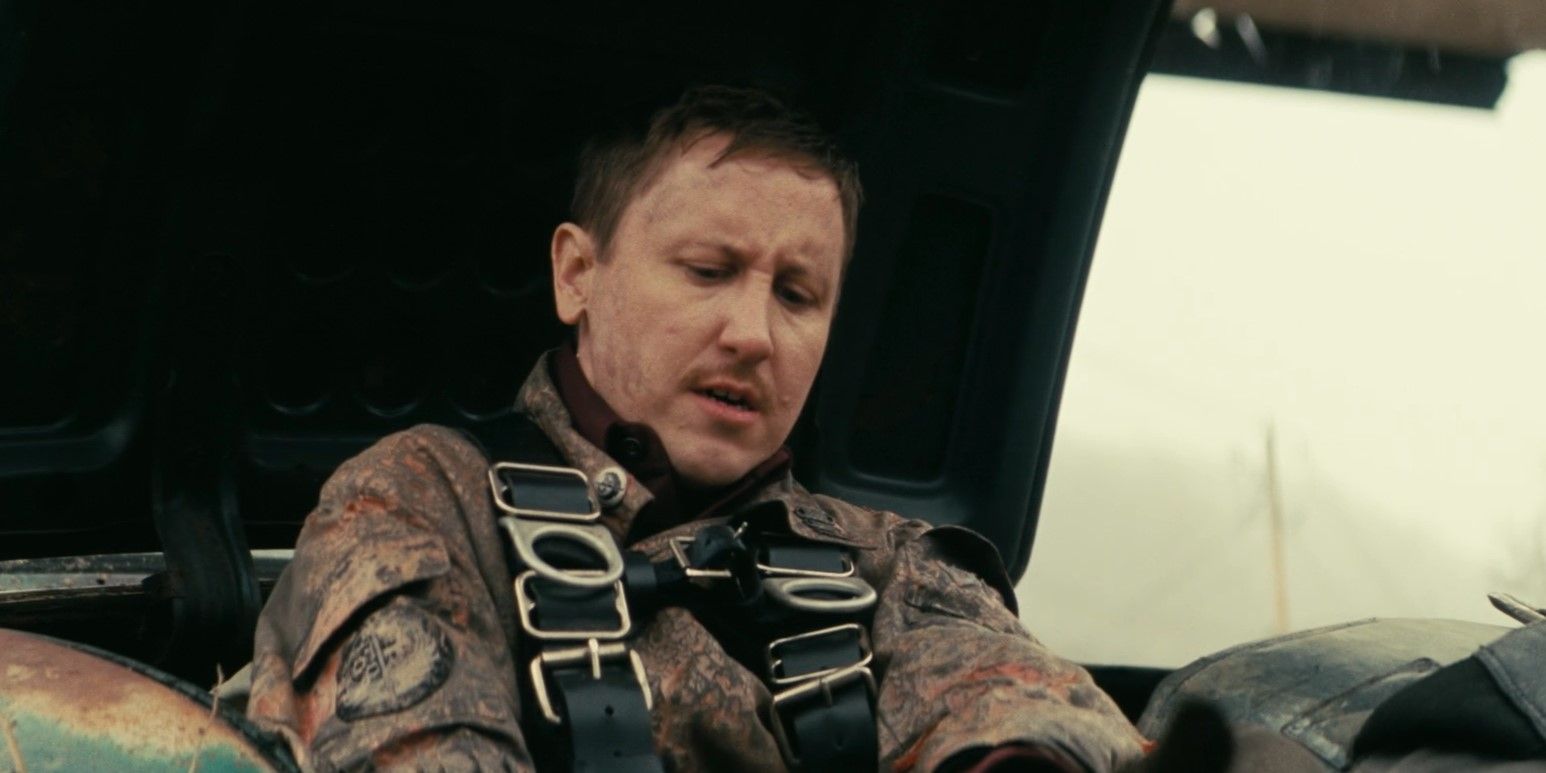 Thaddeus (Johnny Pemberton) examining his injured foot while sitting in the trunk of a car in Fallout