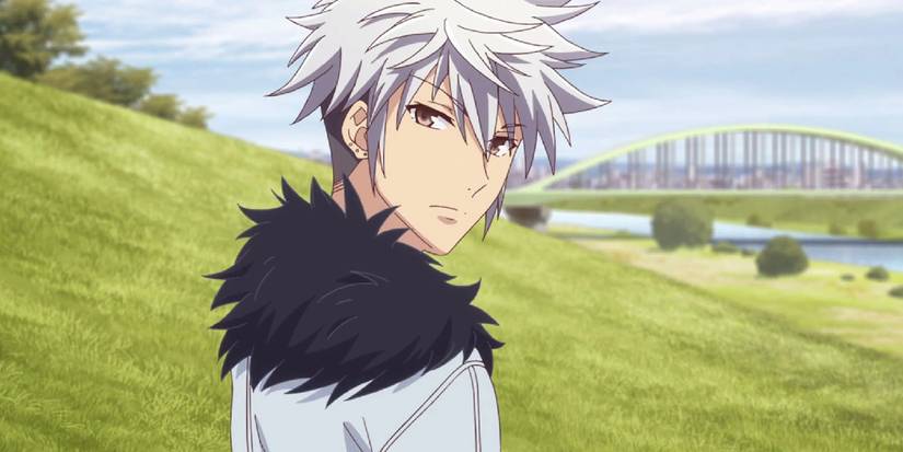 Fruits Basket's Hatsuharu on a Hill looking back with a bridge and grass behind him.