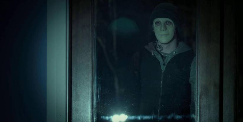 John Gallagher Jr. as The Man Standing Outside the Window Wearing a Mask in Hush 2016