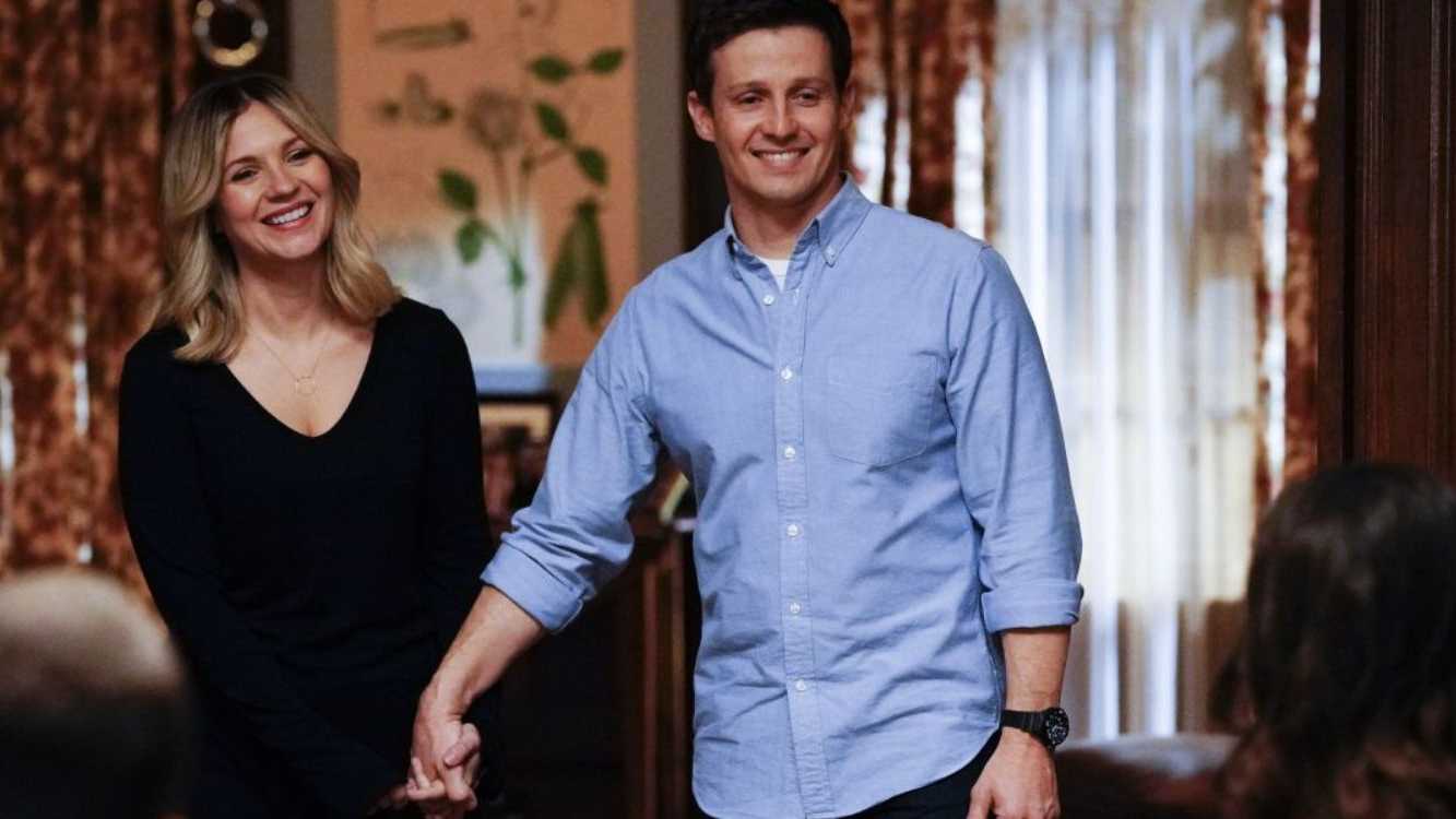 Jamie (Will Estes) and Eddie (Vanessa Ray) holding hands at the Reagan family dinner in Blue Bloods