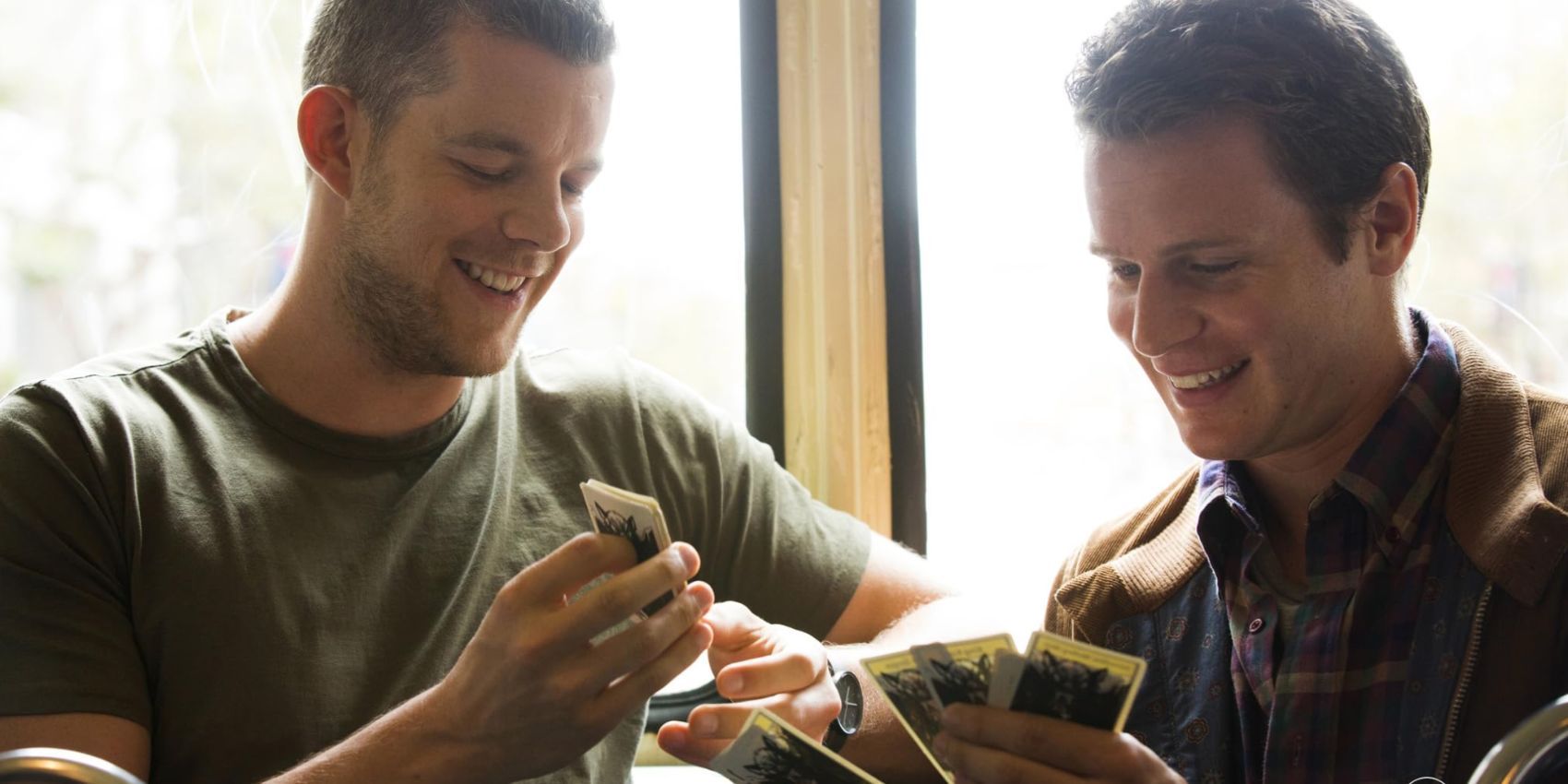 Jonathan Groff and Russell Tovey playing cards in Looking