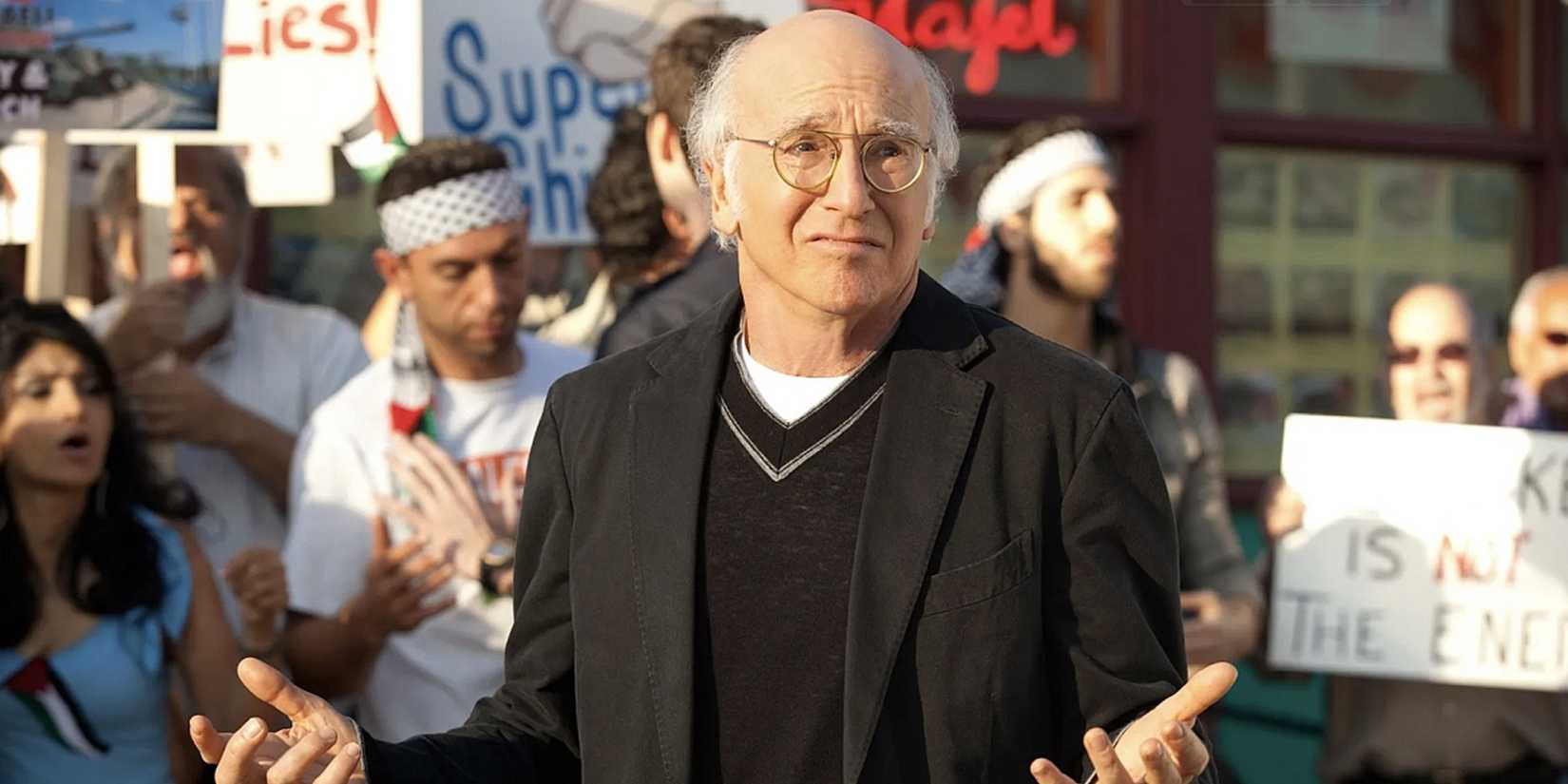 Larry shrugs at a protest in Curb Your Enthusiasm
