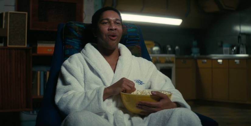 Maximus mange du pop-corn et regarde la télévision dans Fallout