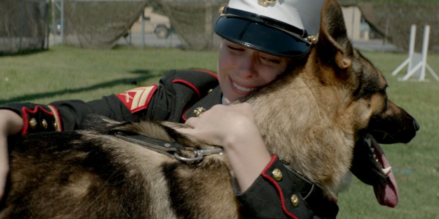 Megan (Kate Mara) holds Rex and looks emotional in Megan Leavey