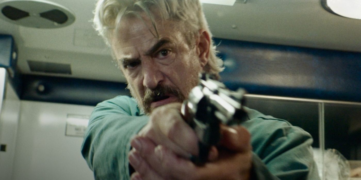 Ray (Dermot Mulroney) pointing a gun in Breakwater