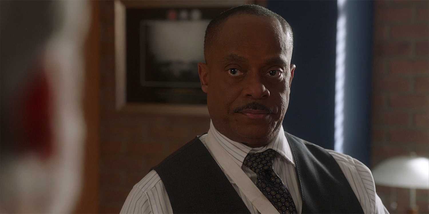Director Leon Vance in a suit and looking to the right in NCIS