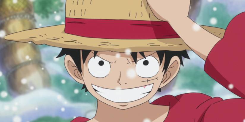 Screenshot from One Piece anime shows Luffy after Time Skip putting on his Straw hat after his training, smiling while it begins to snow.