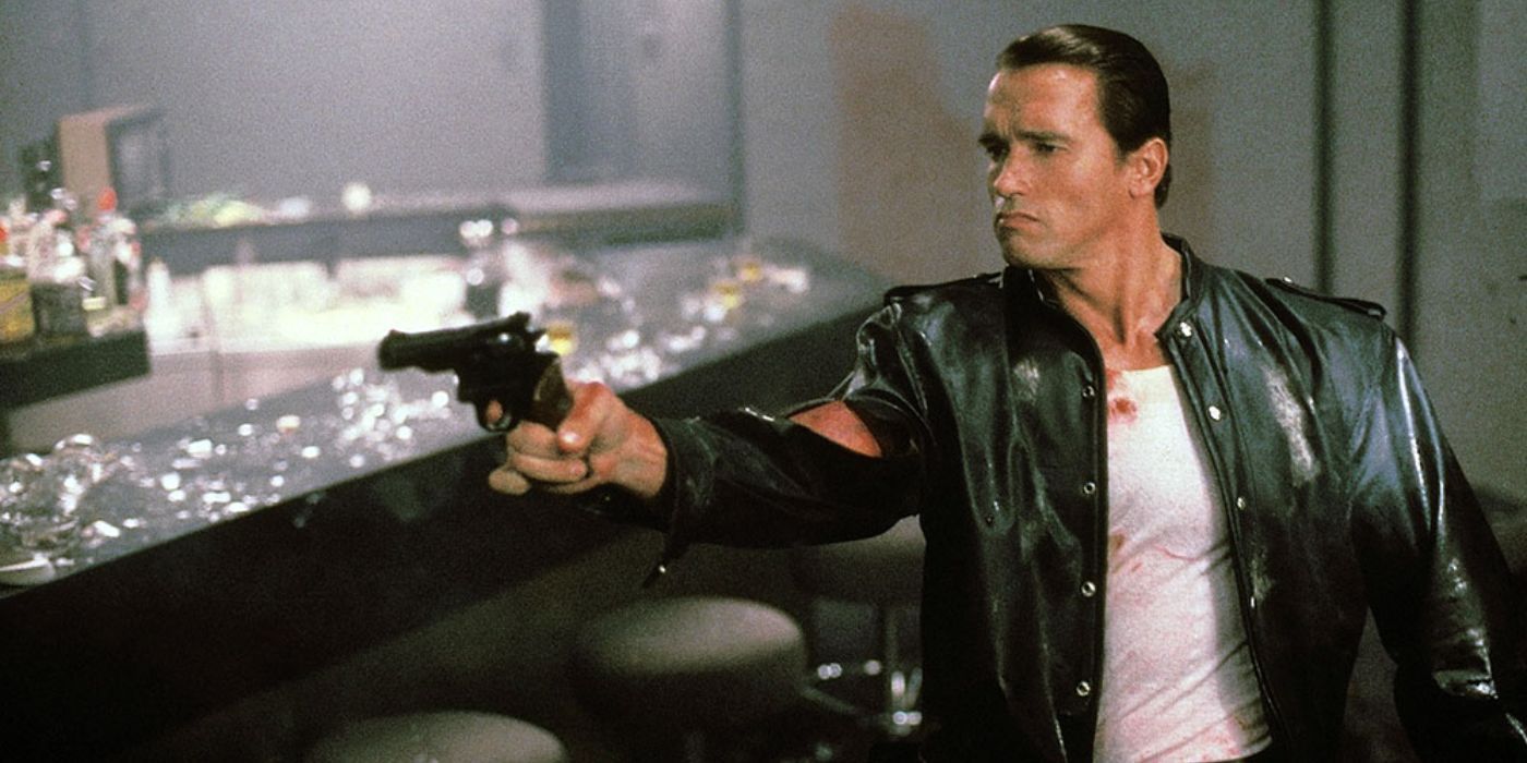 Raw Deal - Arnold Schwarzenegger wears a leather jacket about to shoot a pistol 