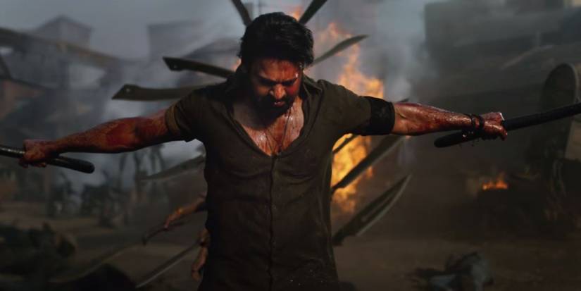 Salaar (Prabhas) holding two swords and flexing in Salaar Part 1 Ceasefire.